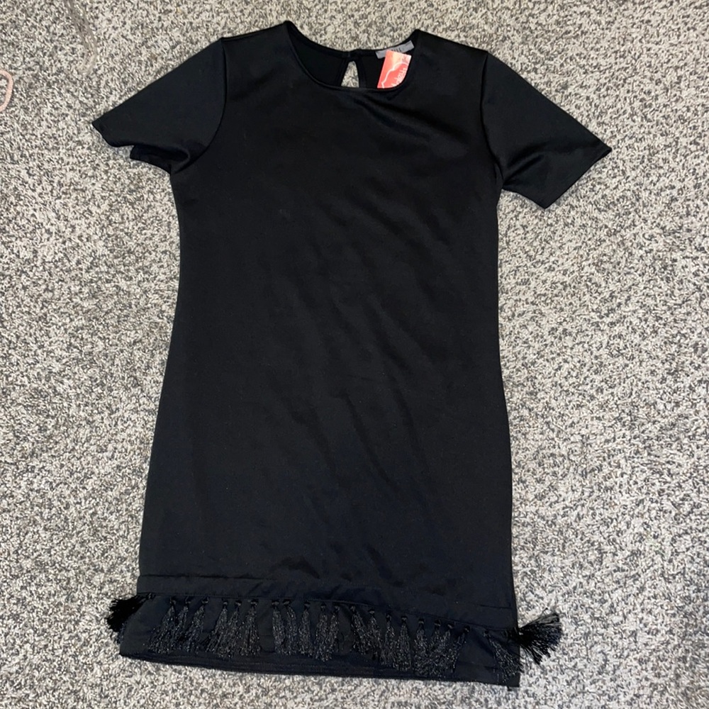 Black dress with tags and tassles on the bottom